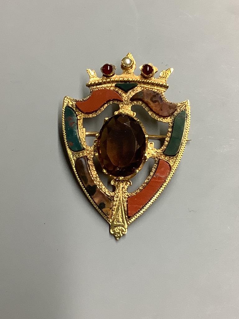 A late Victorian 15 carat gold citrine, seed pearl, cabochon and Scottish hardstone set shield brooch, 46 mm, gross 9.9 g.